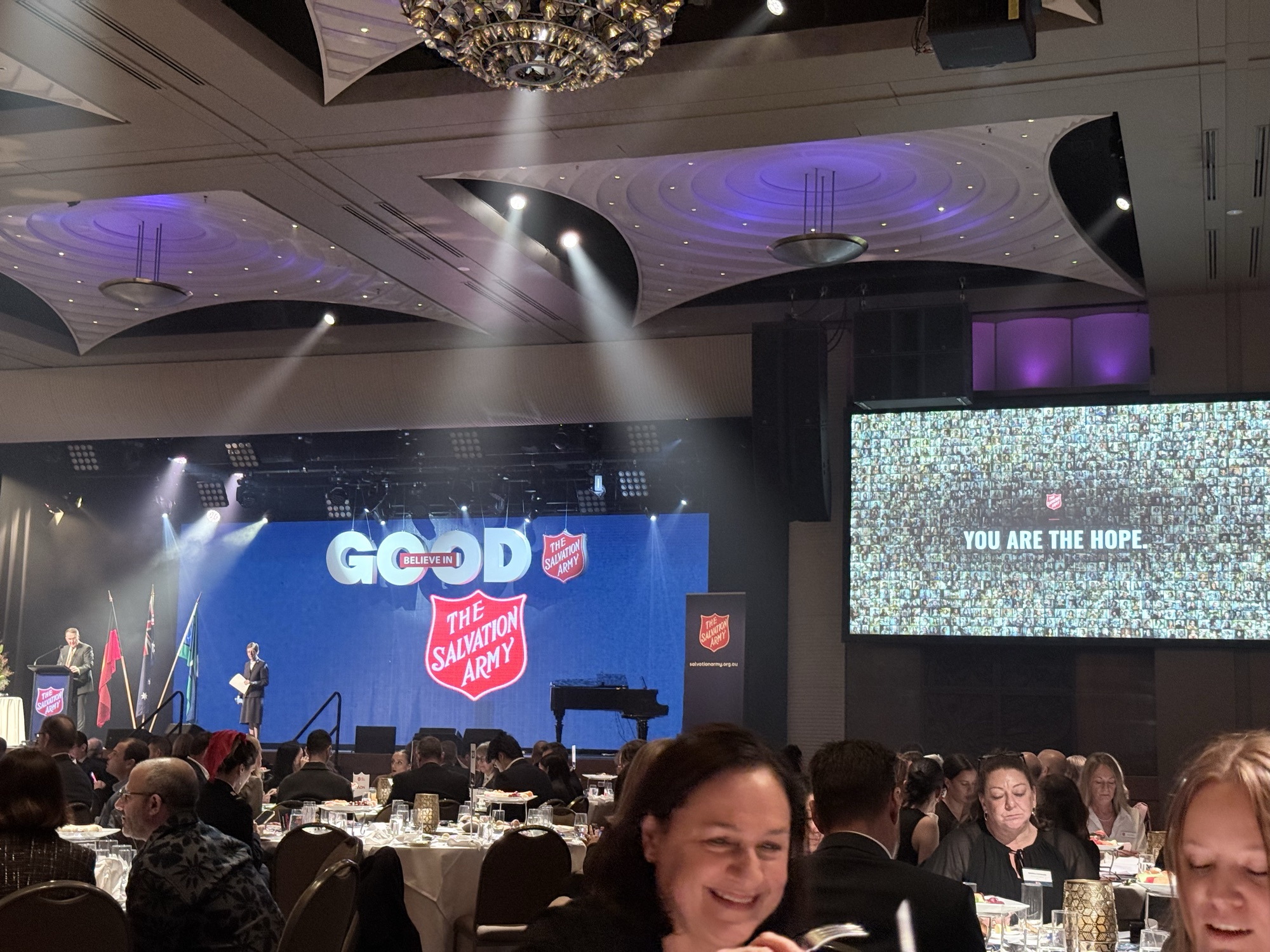 The donation wall running on the gala's big screen above a full ballroom